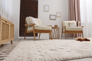 Photo of Stylish living room with soft white carpet and furniture, low angle view. Interior design