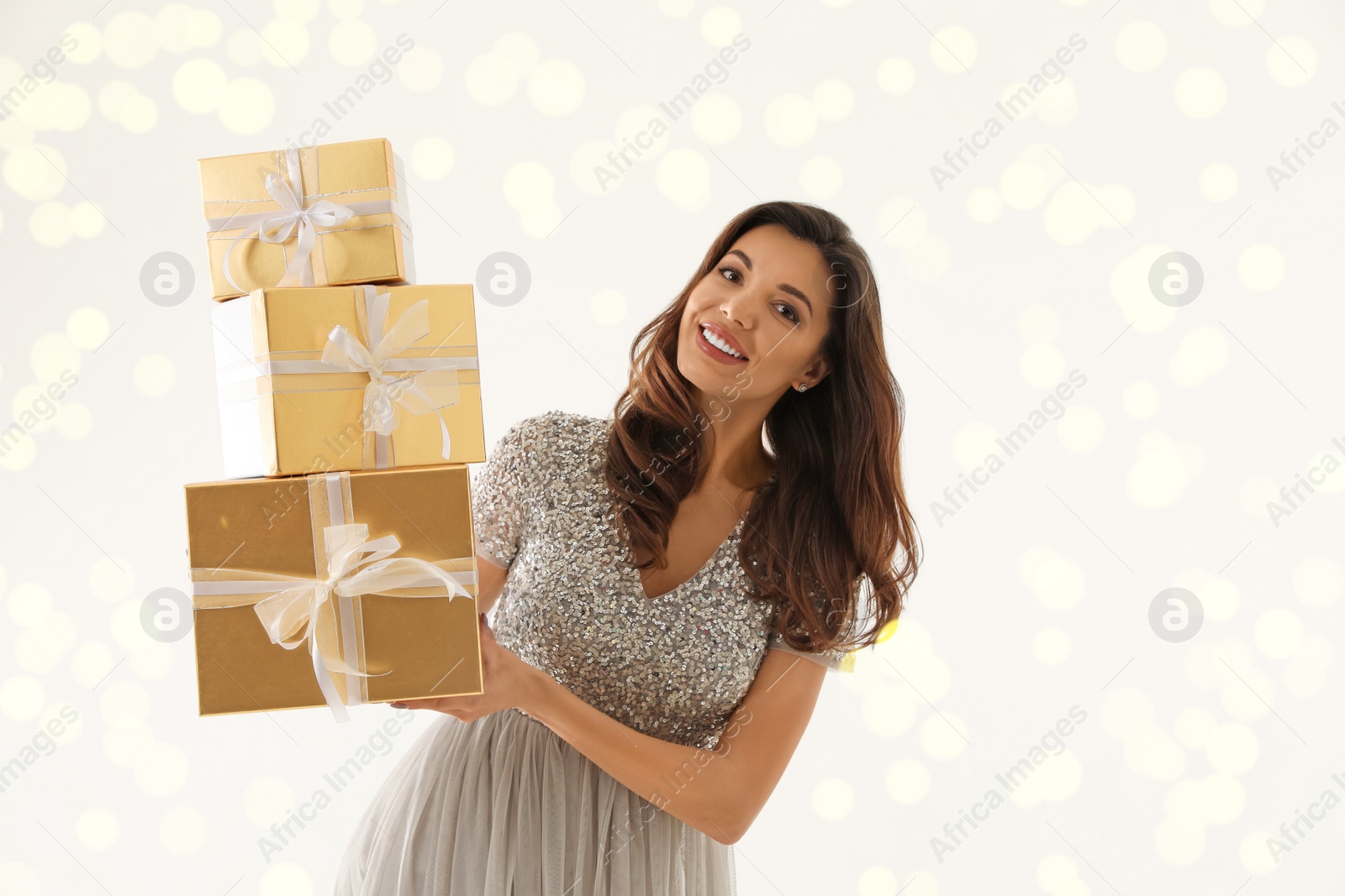 Photo of Beautiful woman with Christmas gifts on white background