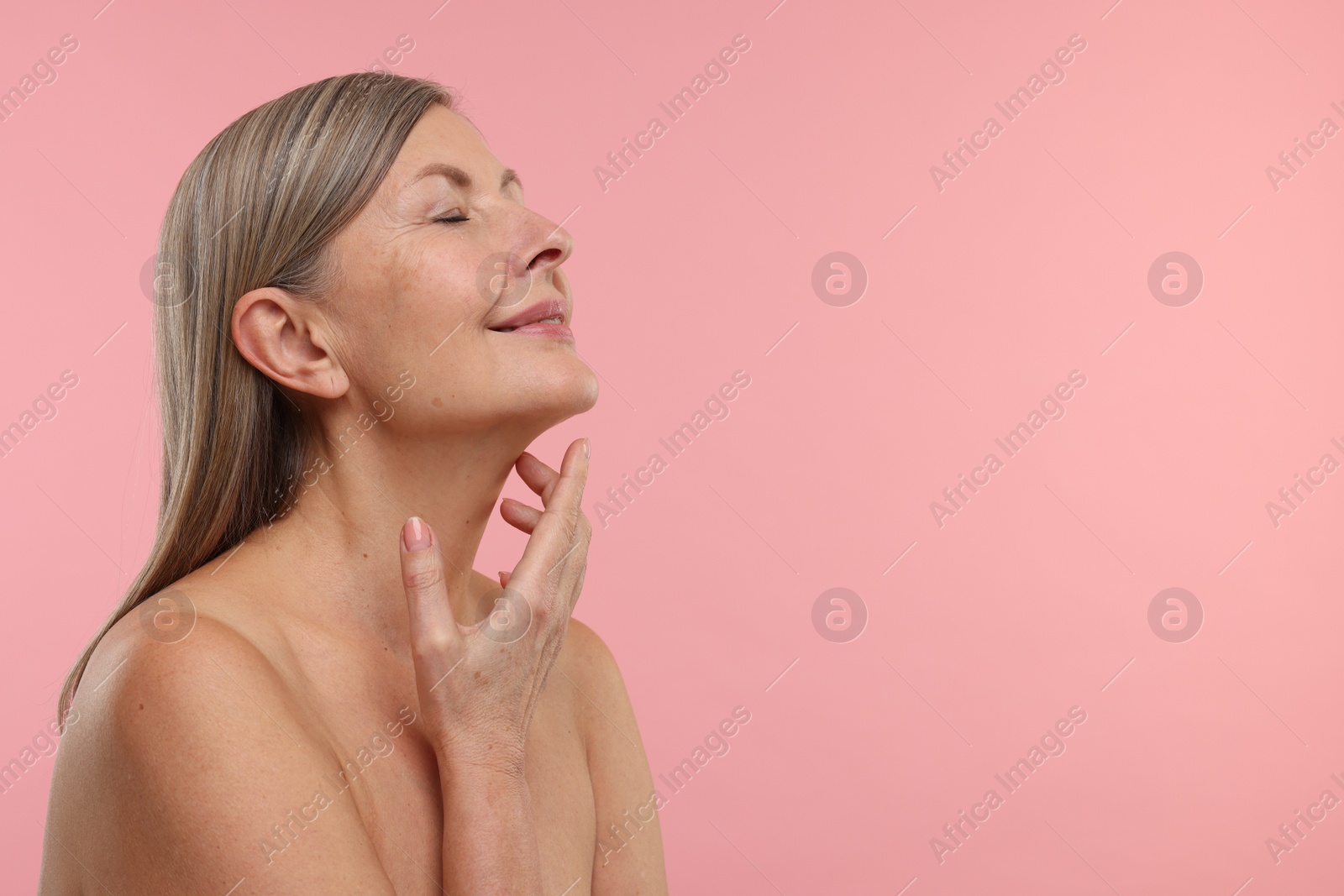 Photo of Beautiful woman with healthy skin on pink background, space for text