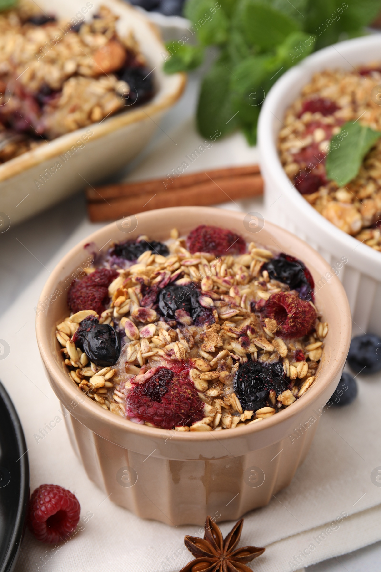 Photo of Tasty baked oatmeal with berries and anise star on table