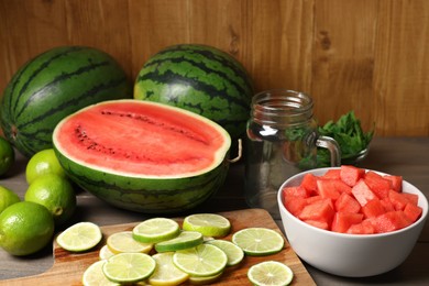 Photo of Fresh ingredients for making watermelon drink with lime on wooden table