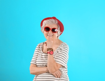 Photo of Portrait of cool grandmother on color background