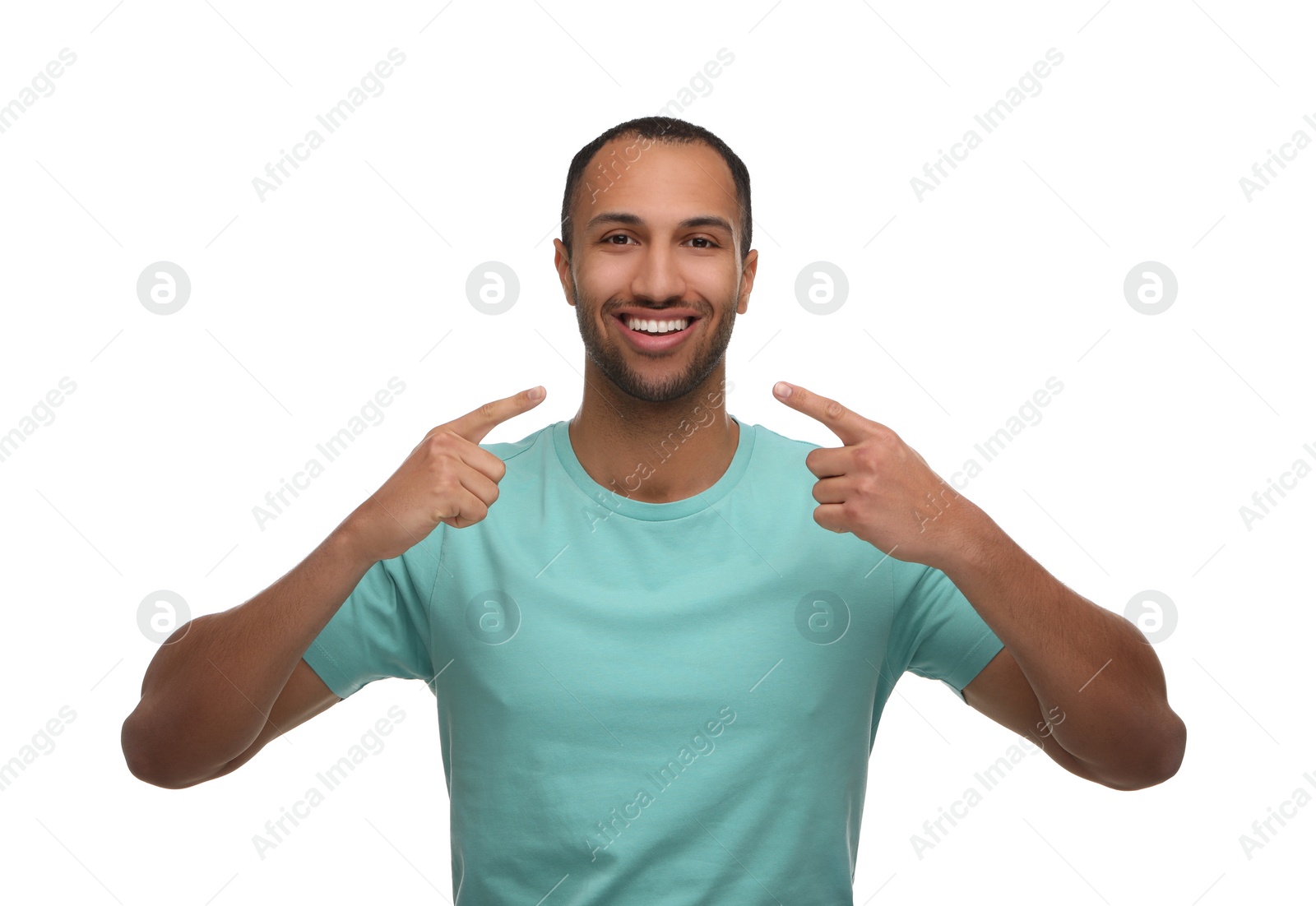 Photo of Smiling man pointing at his healthy clean teeth on white background