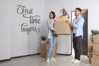Image of First-time buyer. Happy couple with moving boxes entering their new apartment