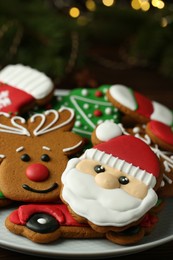 Photo of Different tasty Christmas cookies on white plate, closeup. Space for text
