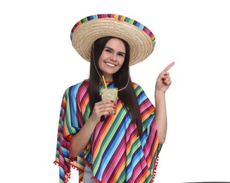 Young woman in Mexican sombrero hat and poncho with cocktail on white background