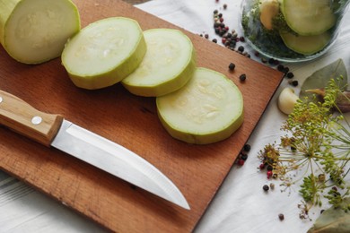 Cut fresh zucchini and ingredients on table. Pickling vegetables