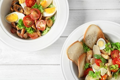 Photo of Plates with delicious fresh salads on table, top view