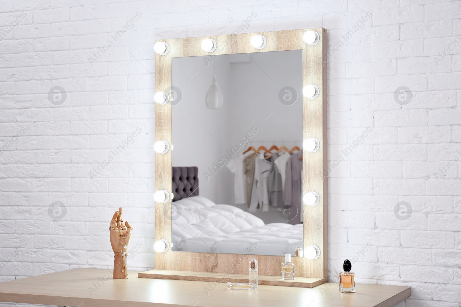 Photo of Makeup mirror on table near white wall in dressing room