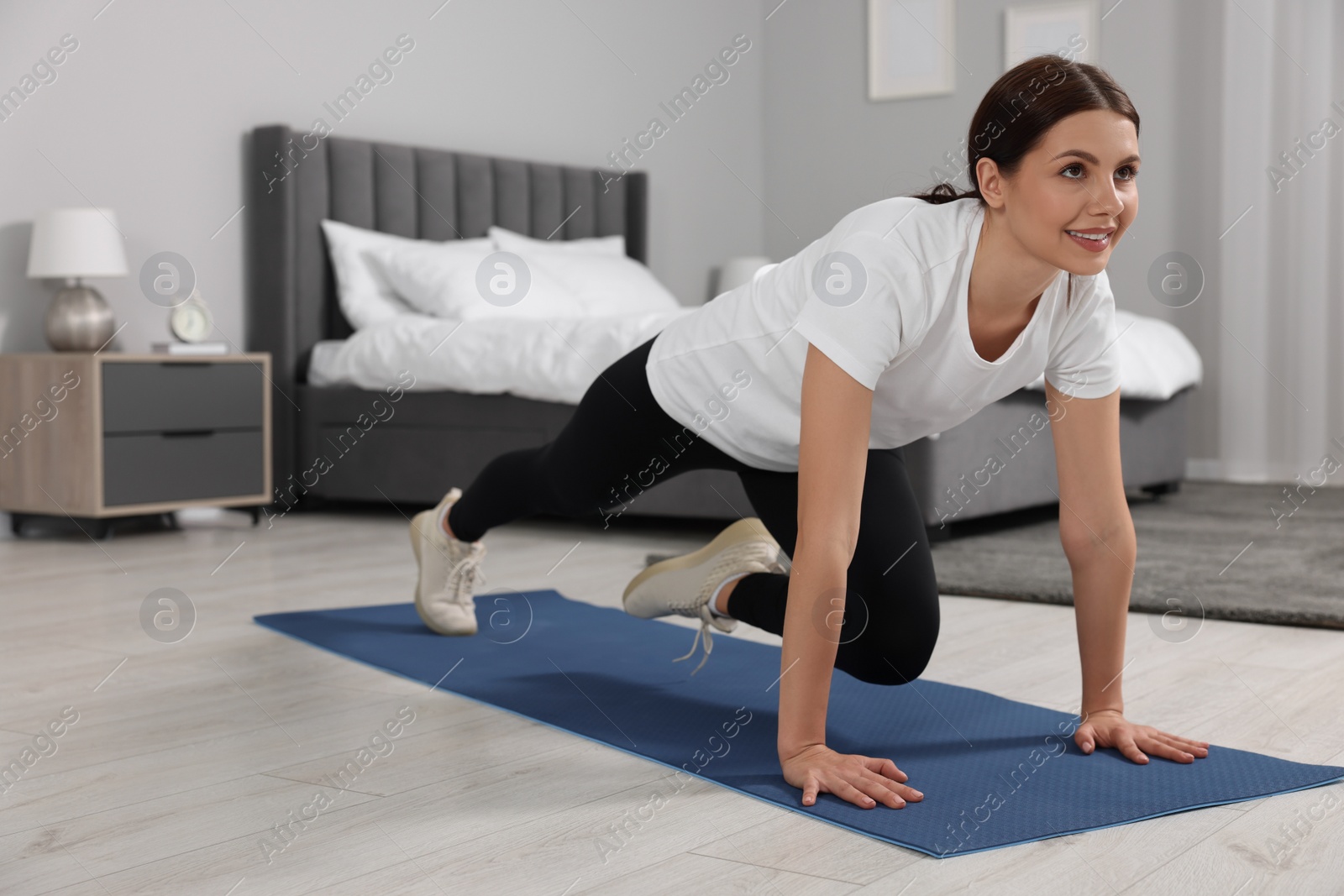 Photo of Happy woman doing abs exercise at home, space for text. Morning routine