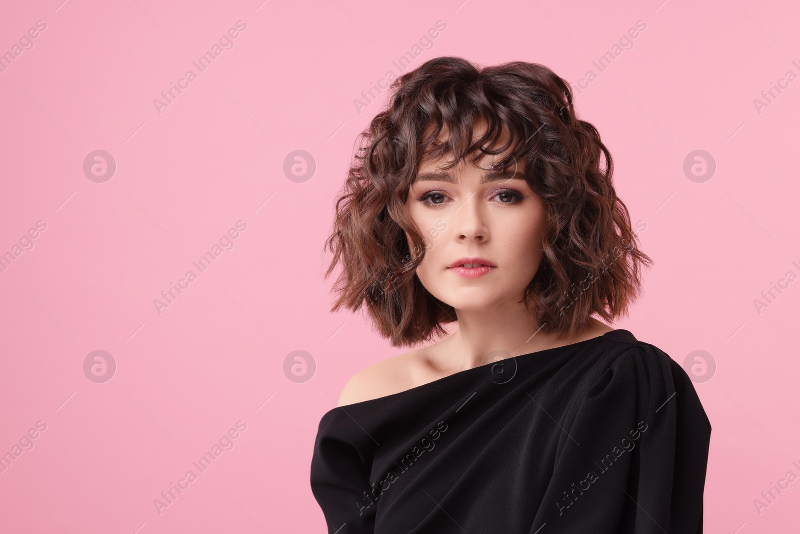 Photo of Portrait of beautiful young woman with wavy hairstyle on pink background. Space for text