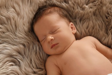 Photo of Cute newborn baby sleeping on fluffy blanket, closeup