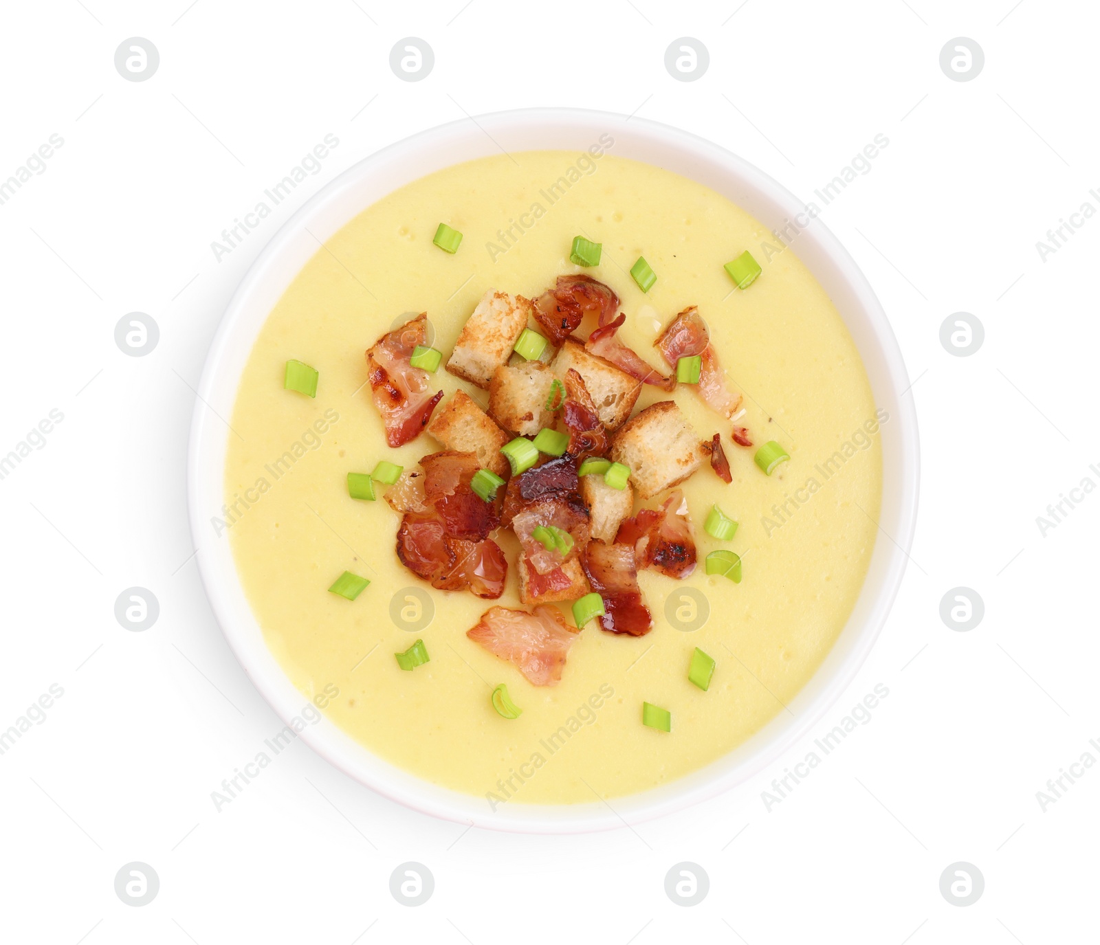 Photo of Tasty potato soup with bacon, croutons and green onion in bowl isolated on white, top view