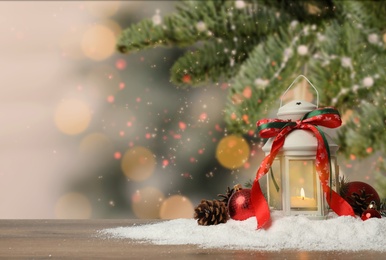 Image of Composition with Christmas lantern on table, space for text. Bokeh effect 