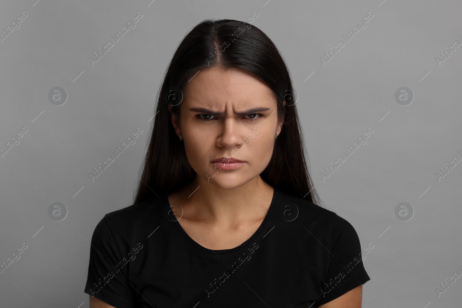 Photo of Personality concept. Emotional woman on grey background