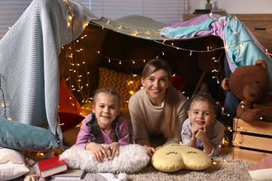 Photo of Mother and her children in play tent at home