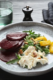 Photo of Plate with delicious beet salad on table, closeup
