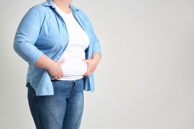 Photo of Overweight woman on light background