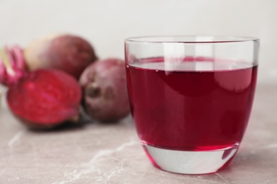 Photo of Glass with fresh beet juice on table