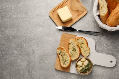 Photo of Tasty baguette with garlic and dill served on light grey table, top view. Space for text