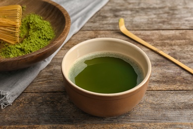 Photo of Chawan with fresh matcha tea on table