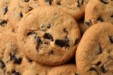 Photo of Delicious chocolate chip cookies as background, closeup