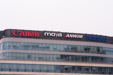 Photo of Warsaw, Poland - September 10, 2022: Building with many modern logos