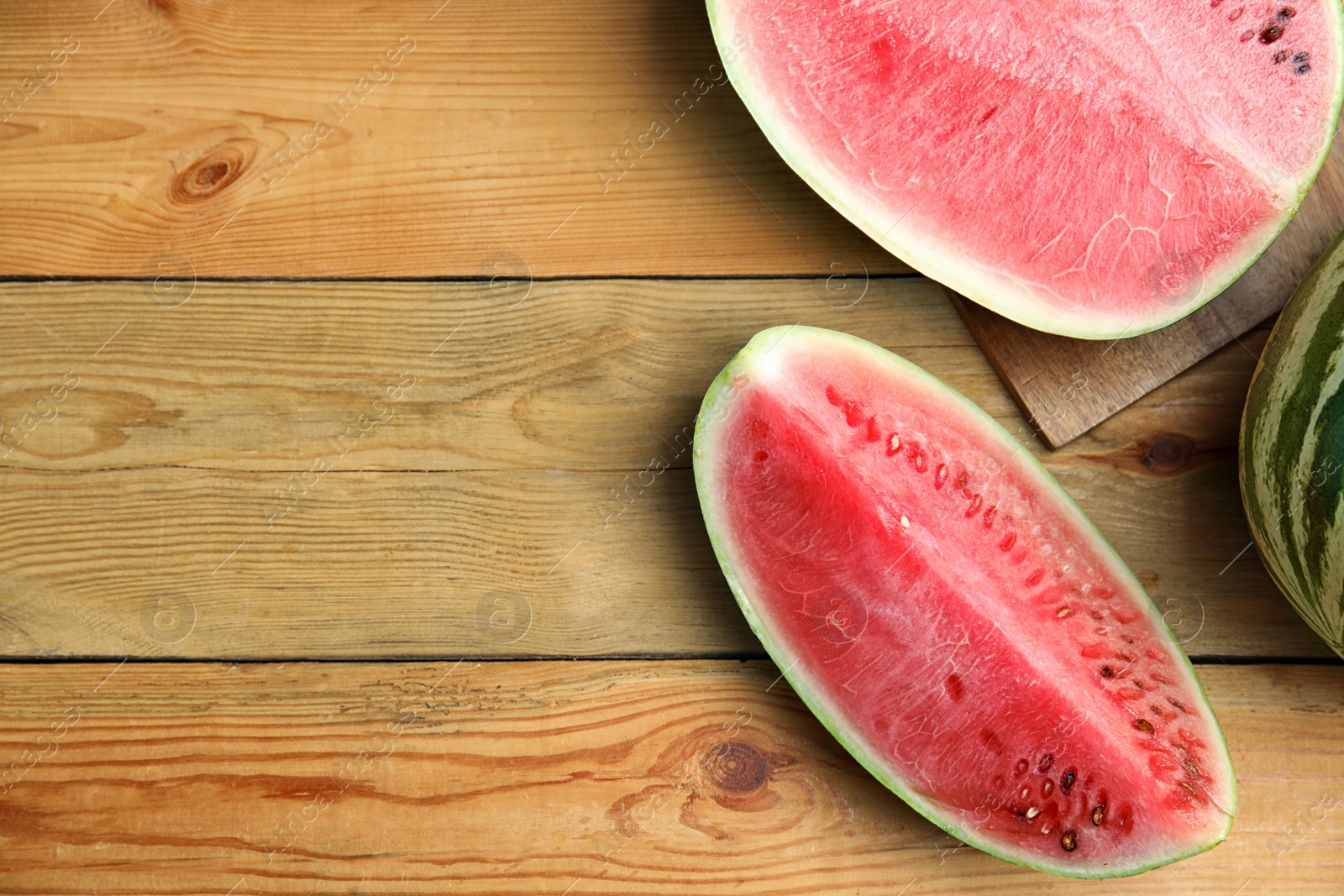 Photo of Yummy watermelon on wooden table, flat lay. Space for text