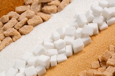 Different types of sugar as background, closeup