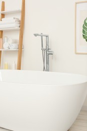 Photo of Stylish white tub in bathroom. Interior design