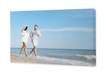 Image of Photo printed on canvas, white background. Happy young couple running together on beach