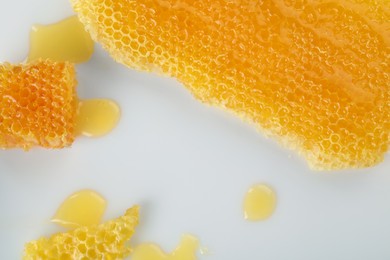 Photo of Natural honeycombs with tasty honey on white background, flat lay