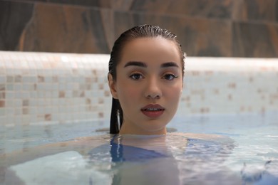Photo of Beautiful woman relaxing in spa swimming pool