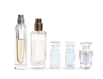 Different perfume bottles on white background