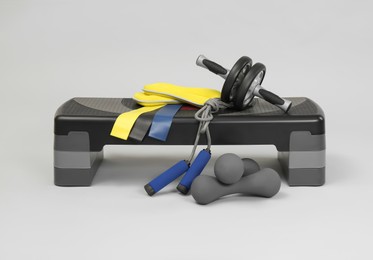 Photo of Step platform and other sport equipment on light background