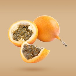 Delicious ripe granadillas falling on pale orange background