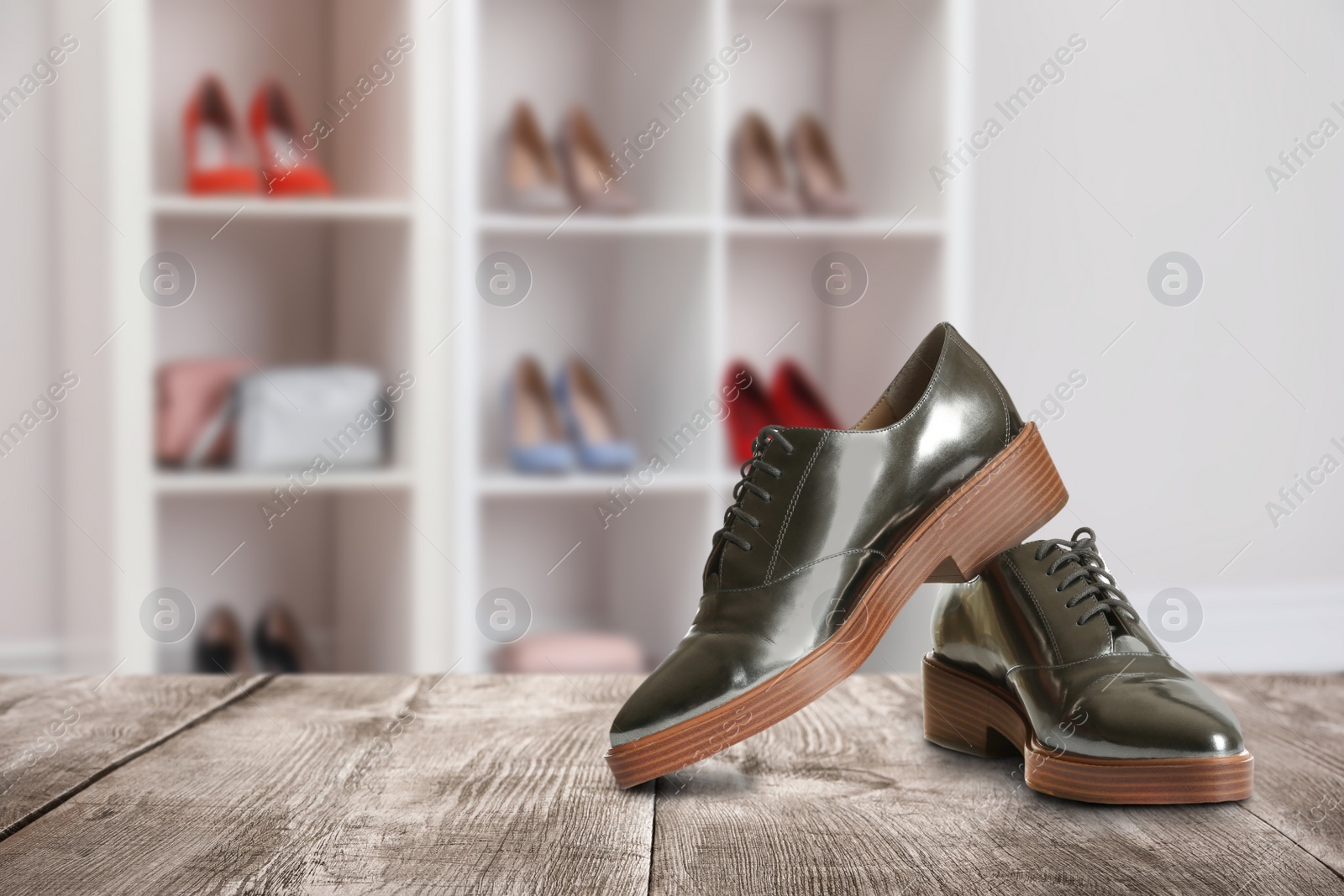 Image of Elegant shoes on wooden surface in store, space for text 