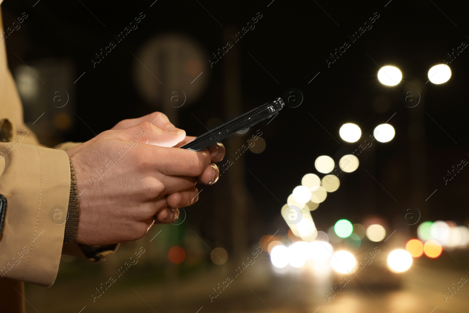 Photo of Man using smartphone on night city street, closeup. Space for text