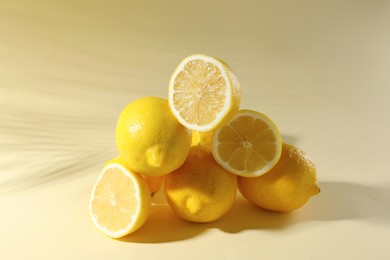Pile of fresh lemons on light background