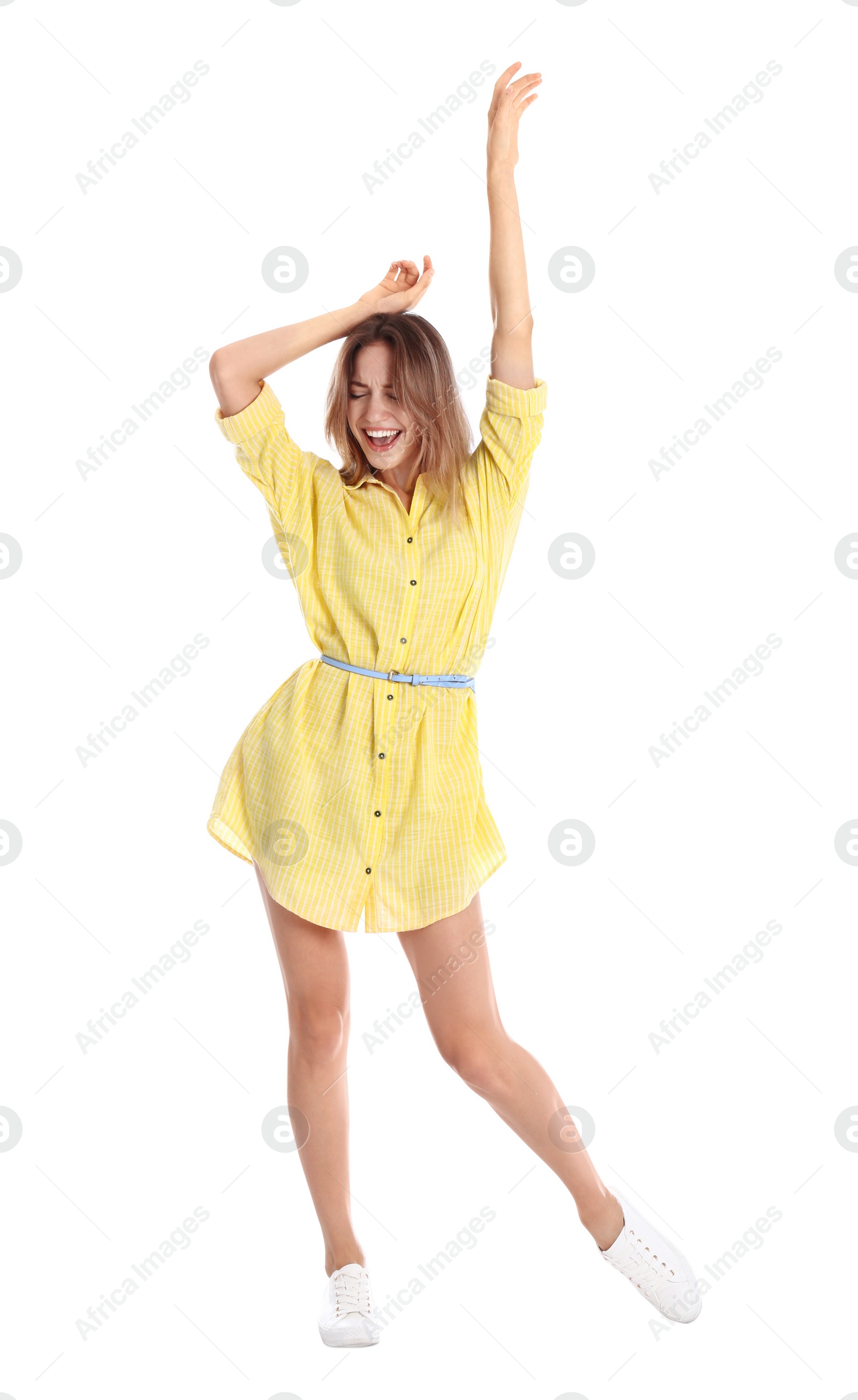 Photo of Beautiful young woman in yellow dress dancing on white background