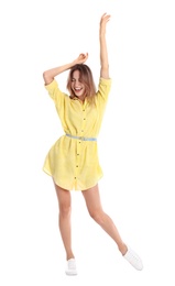 Beautiful young woman in yellow dress dancing on white background