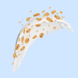 Image of Rolled oats and milk splash on light blue background