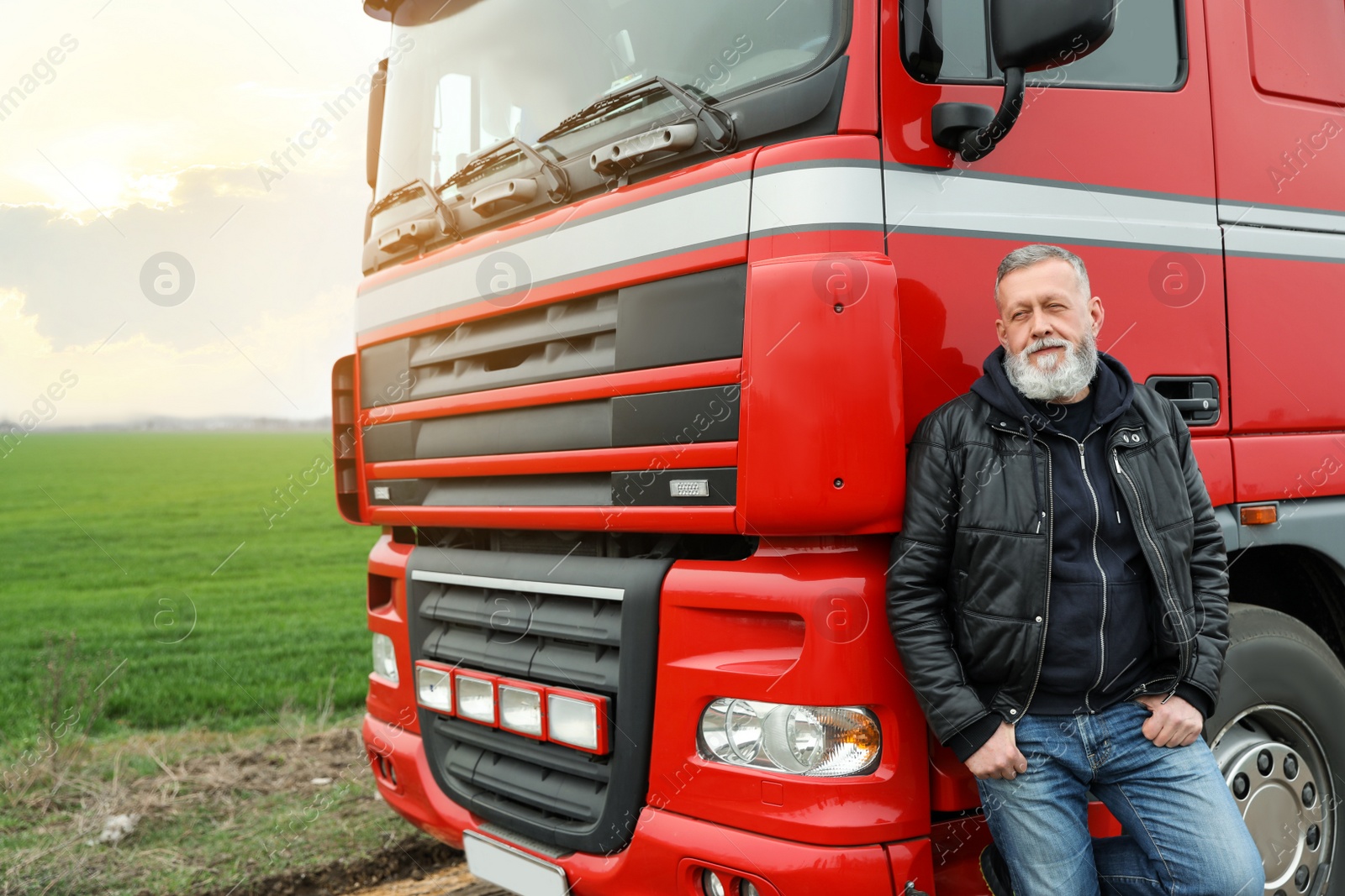 Photo of Portrait of mature driver at modern truck outdoors. Space for text
