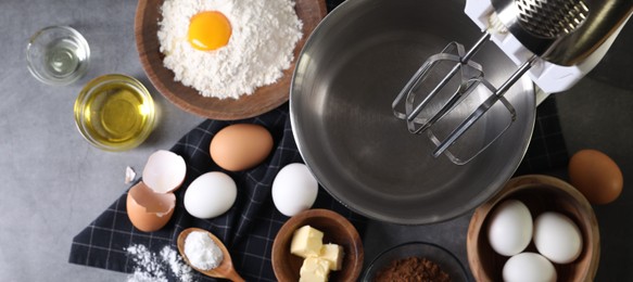 Photo of Stand mixer and different ingredients for dough on grey table, flat lay