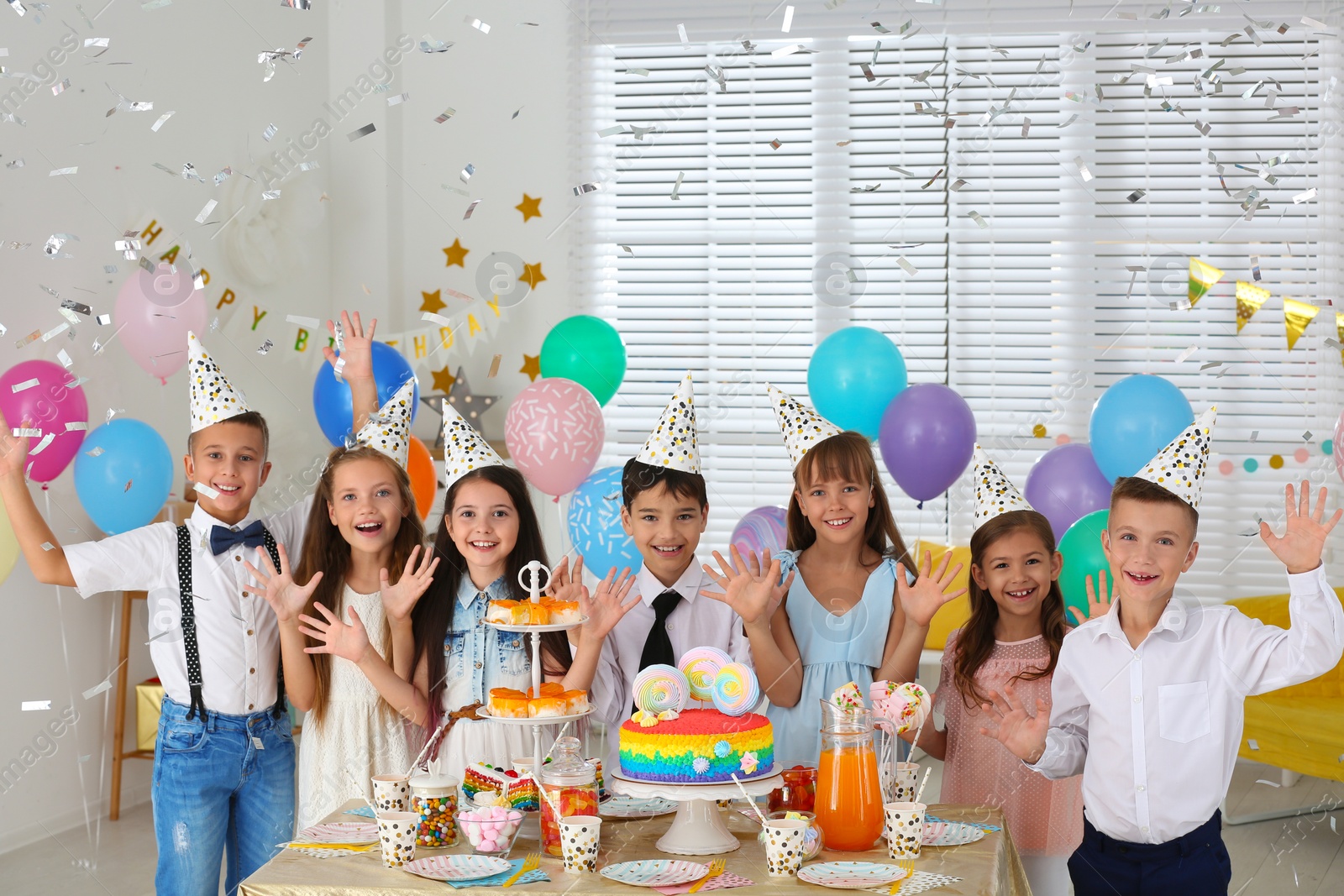 Photo of Happy children at birthday party in decorated room