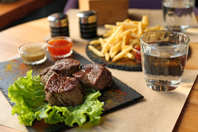 Tasty pieces of shish kebab served on slate plate in cafe