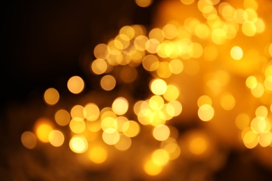 Gold glitter with bokeh effect on dark background