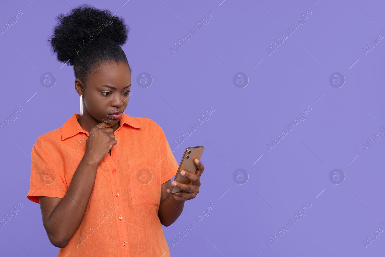 Photo of Beautiful young woman with smartphone on purple background. Space for text
