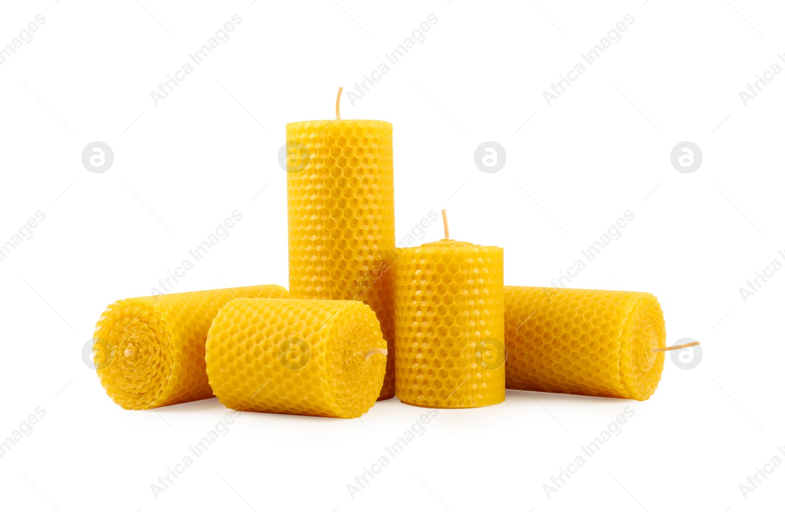 Image of Set of beeswax candles on white background