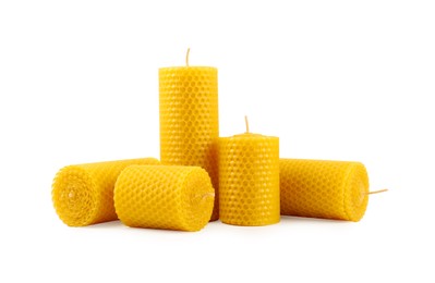 Image of Set of beeswax candles on white background